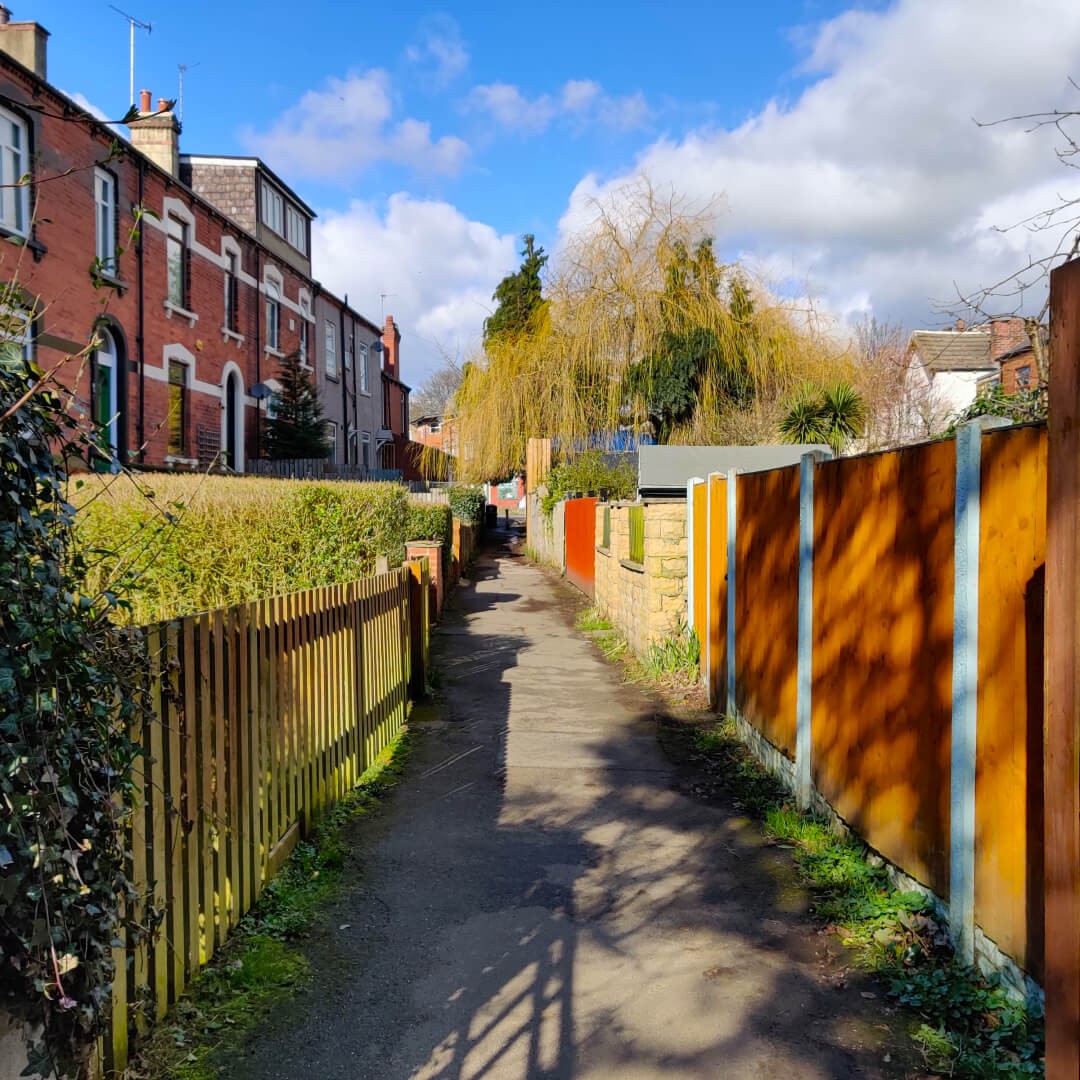 Small ginnel or footpath behind houses along the Meanwood Valley Trail